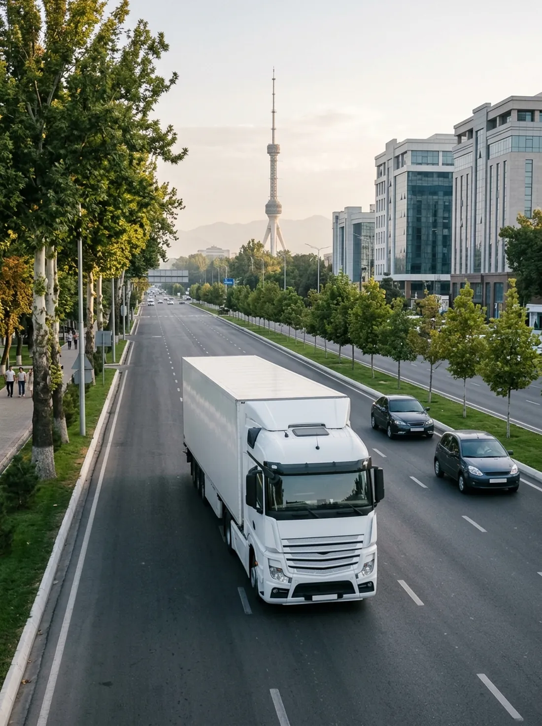 A big white truck on a Tashkent avenue with the Tashkent TV Tower behind